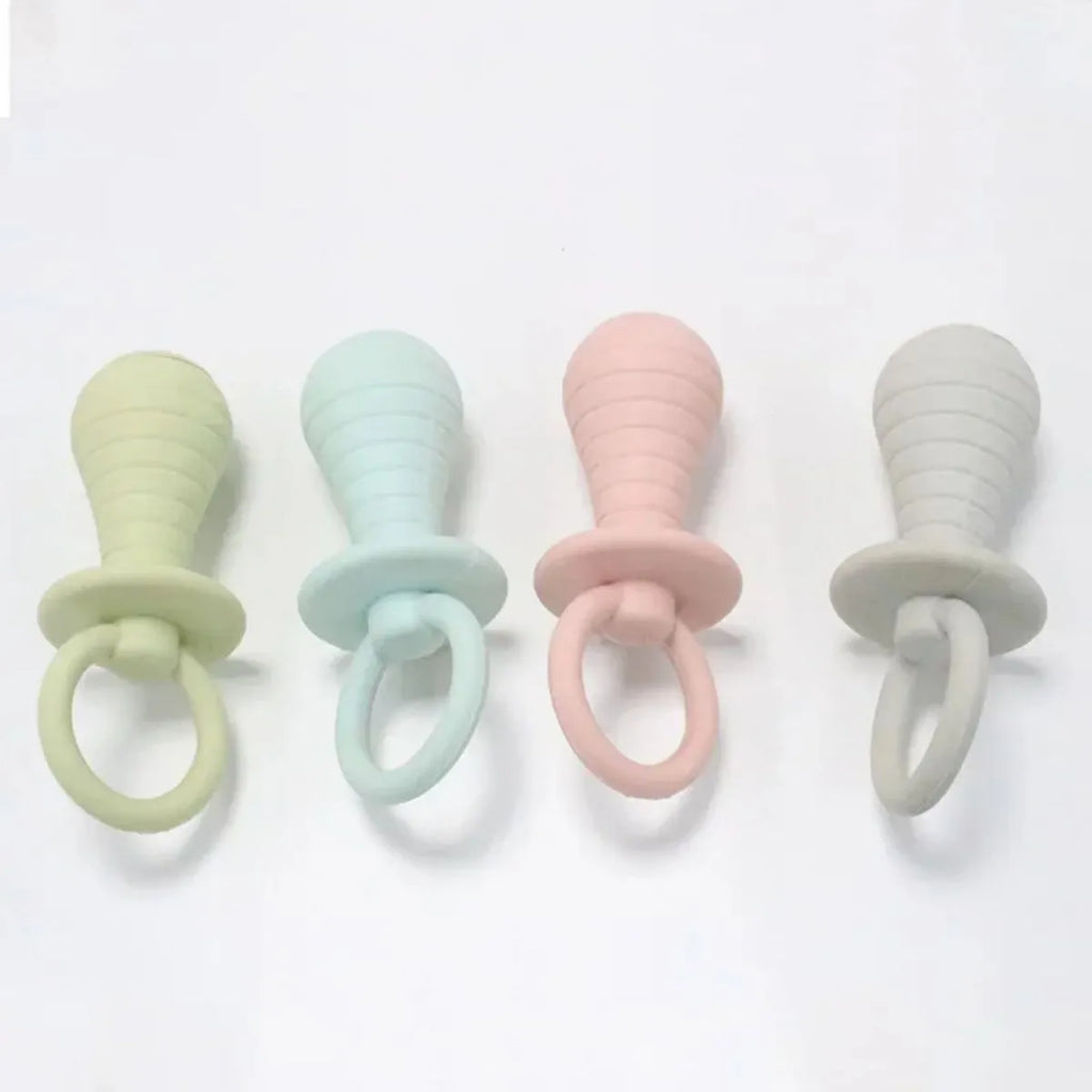 Four TPR rubber pet pacifier chew toys with squeakers in blue, grey, green, and pink colours