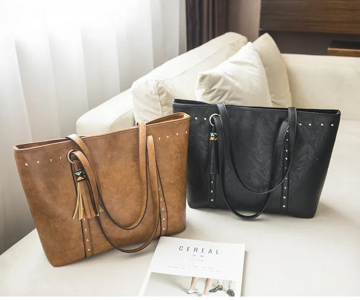 Women's shoulder crossbody tote bag in black with crossbody strap and open top