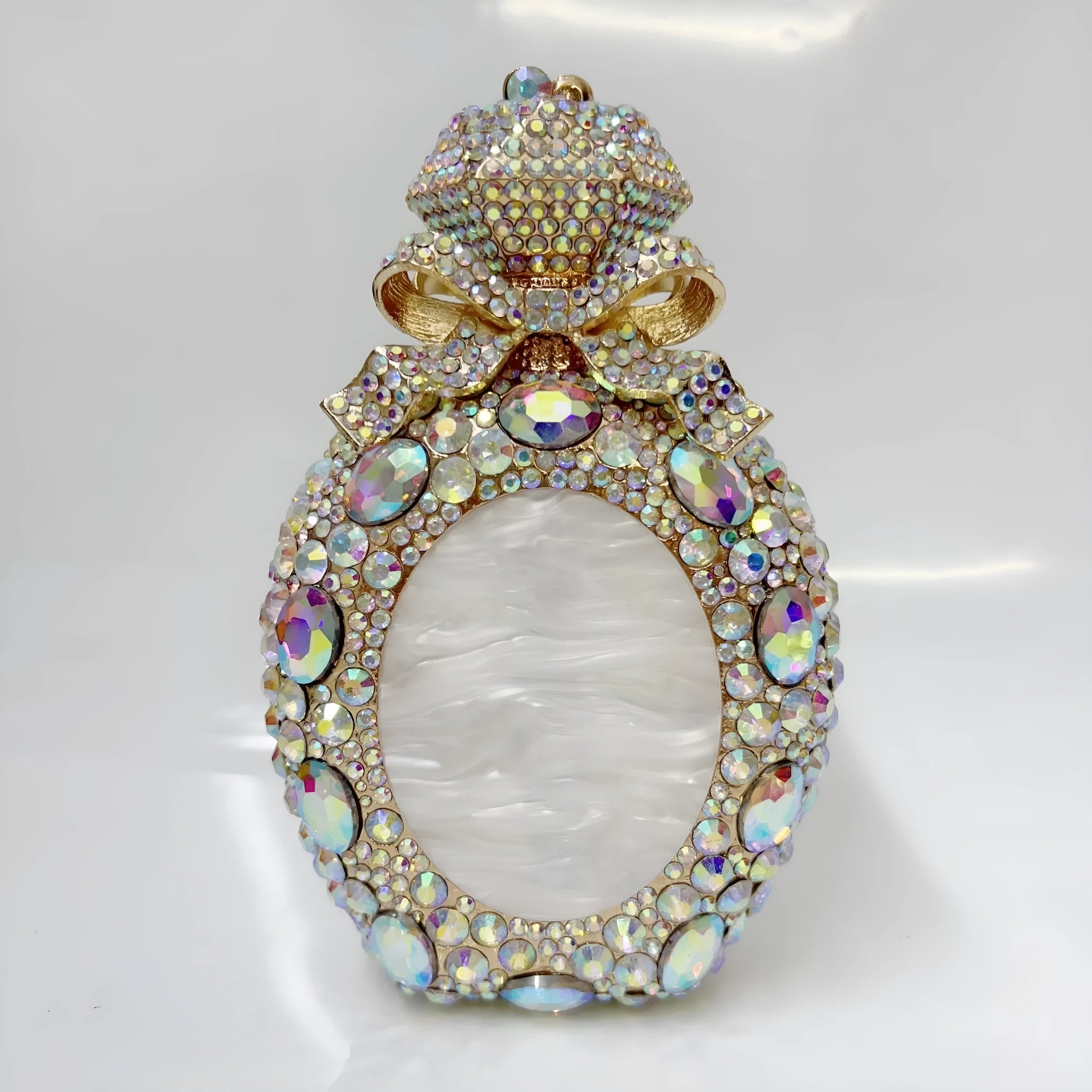 Women's alloy clutch bag with three-dimensional design in metallic colours