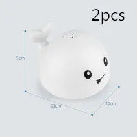 Electric whale-shaped bath spray toy with water-activated automatic spray, LED lights, and floating capability