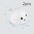Electric whale-shaped bath spray toy with water-activated automatic spray, LED lights, and floating capability
