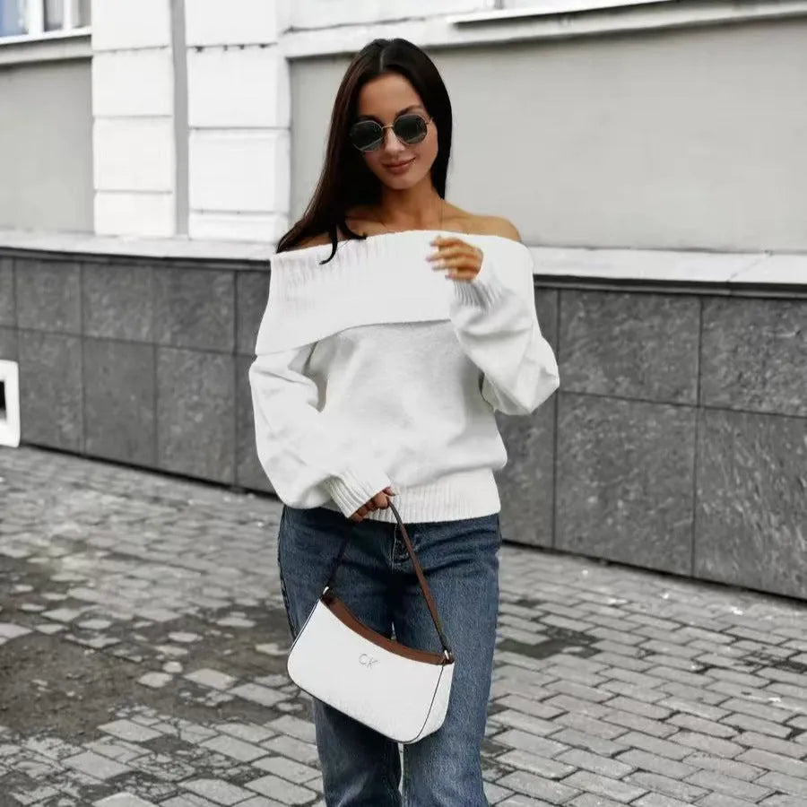 Woman wearing a grey off-the-shoulder sweater with a raised 3D texture pattern.