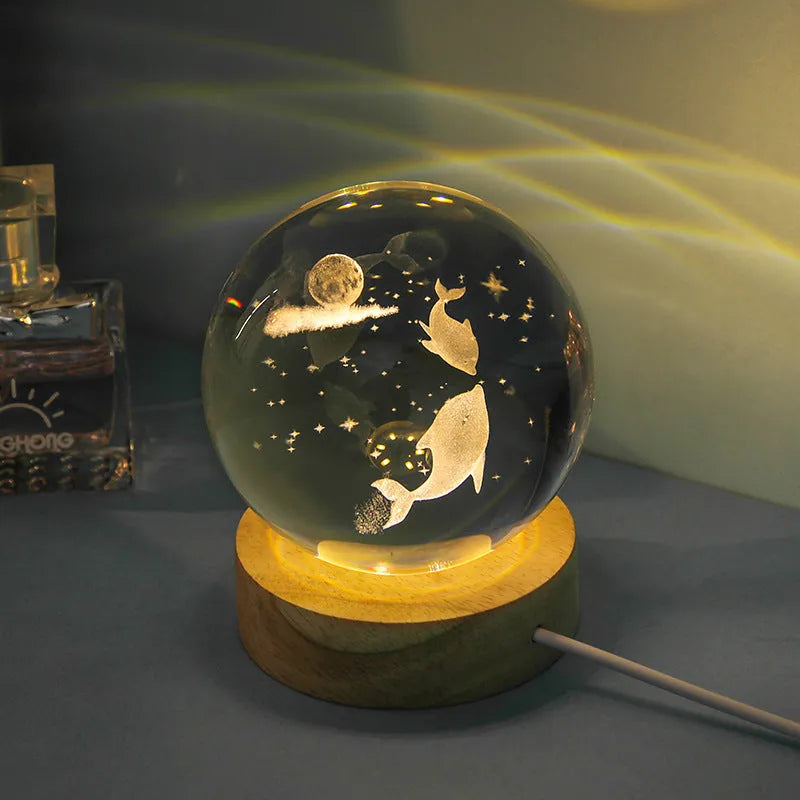 Transparent crystal ball night lamp with 3D carved jellyfish design, on a round base with USB cable.
