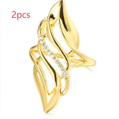 Women's exaggerated curve ring in Q611 gold colour with zircon treatment on copper