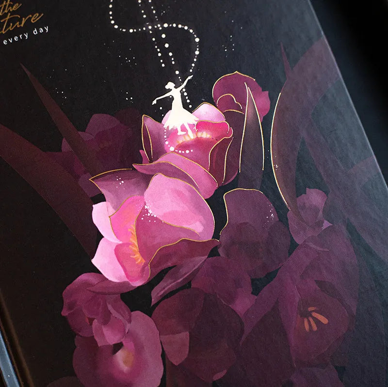 A5 hardback notebook with luminous cover open to show colour illustrated pages.
