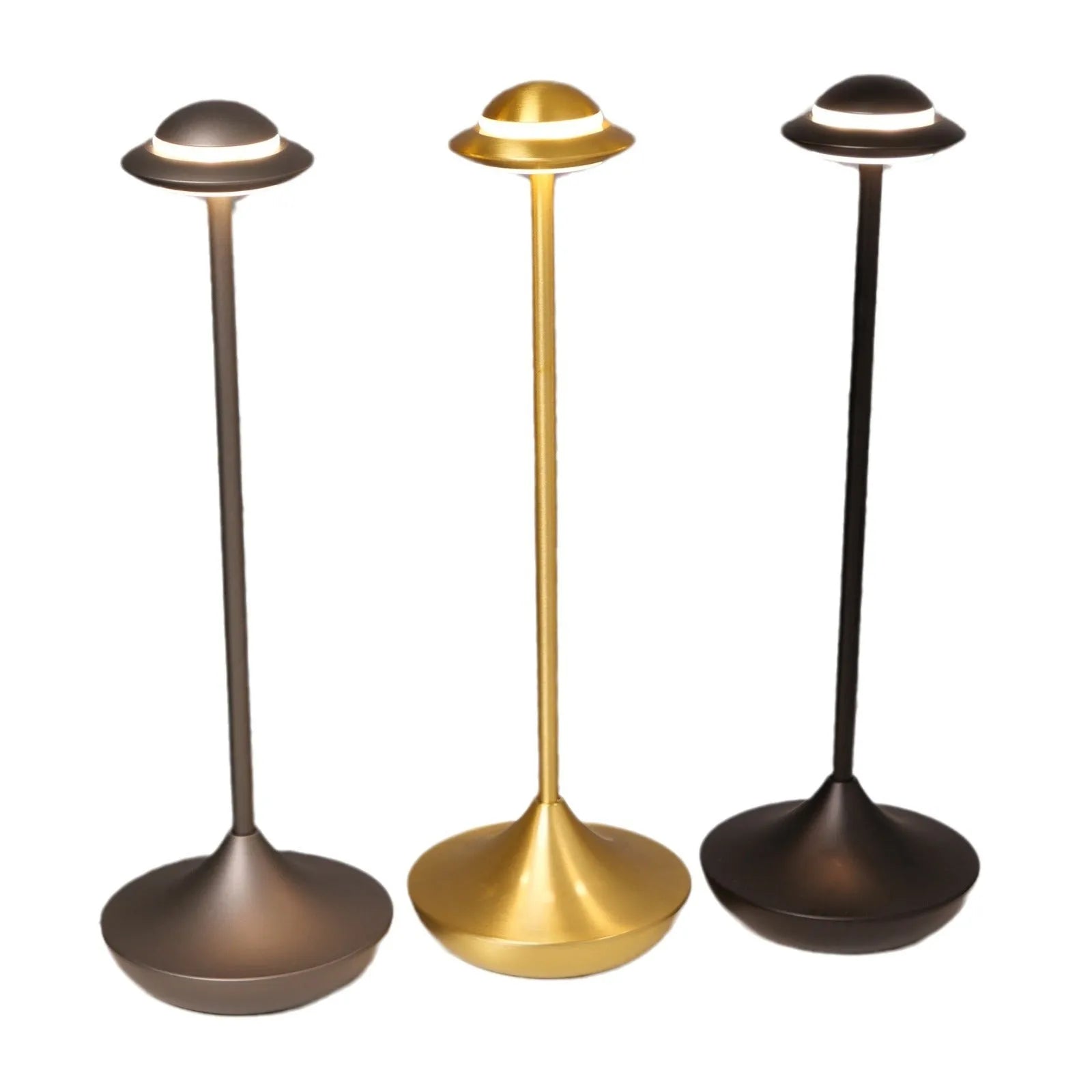 UFO-shaped metal desk lamp with saucer design in grey finish on a wooden table, demonstrating cordless use.