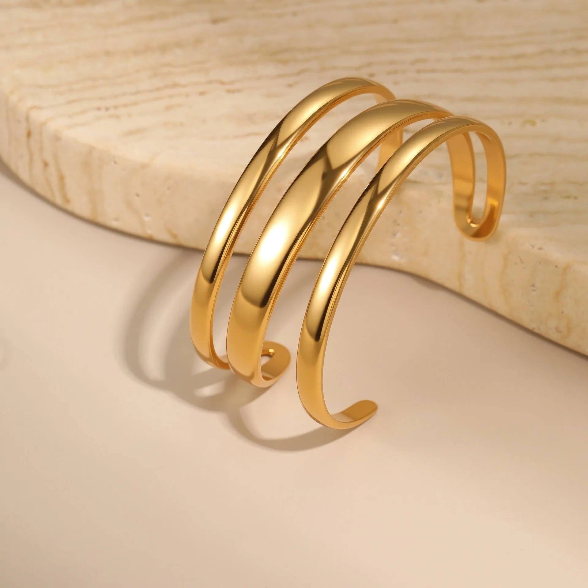 Women's geometric stainless steel bracelet with simple opening clasp in gold tone finish