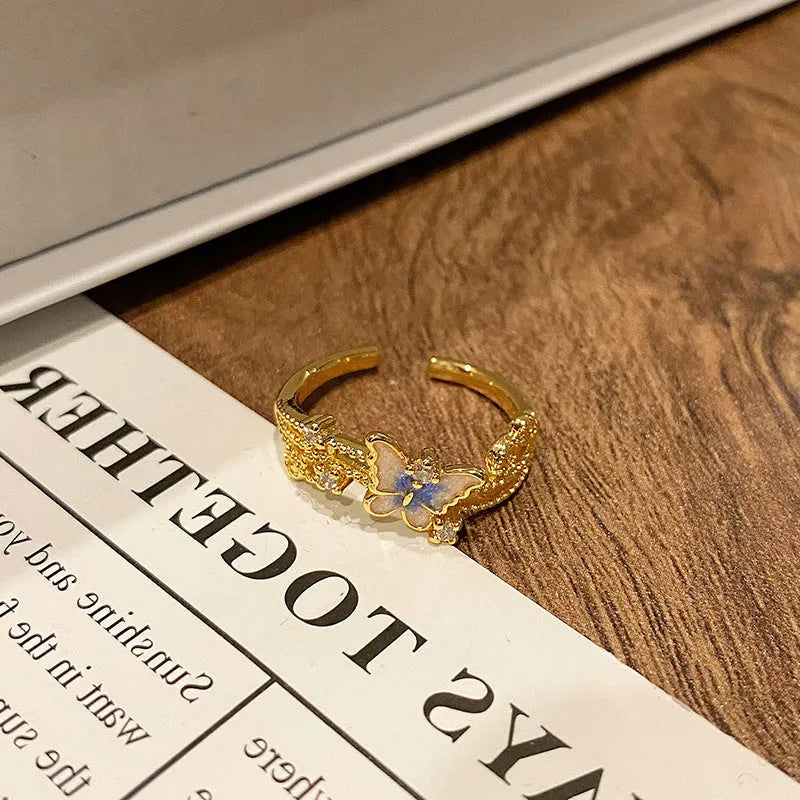 Simple copper women's ring with a Chinese butterfly design, showing an example from the 33 available numbered styles.
