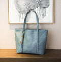 Women's shoulder crossbody tote bag in black with crossbody strap and open top