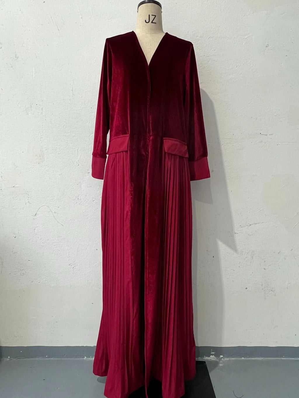 Women's pleated stitching coat in wine red, long sleeves, polyester fabric, street hipster style, front view.