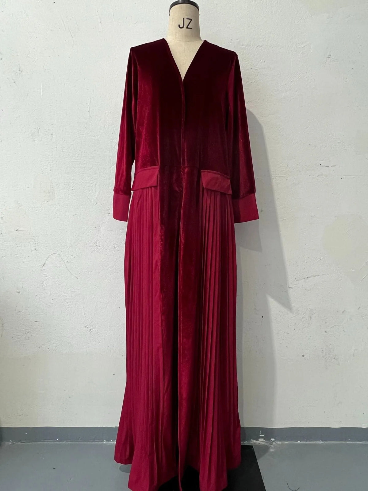 Women's pleated stitching coat in wine red, long sleeves, polyester fabric, street hipster style, front view.