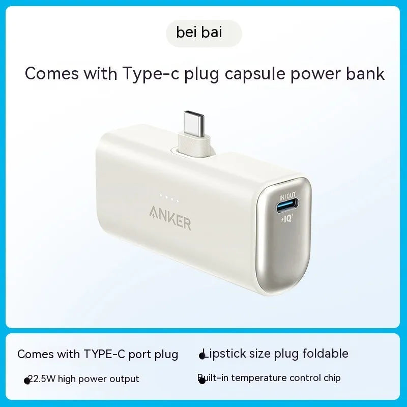 Small capsule-shaped power bank in multiple colours showing built-in foldable USB-C cable and compact size.