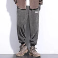 Man wearing grey straight-leg sweatpants with an ankle tie closure.