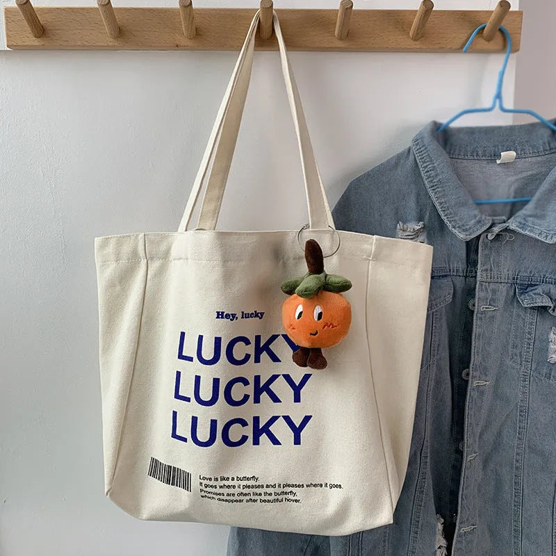 Natural canvas tote bag 32x31.5x10cm with bottom and side panels, small pocket, and metal magnet buckle