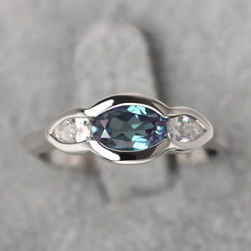 Geometric ellipse ring with zircon inlay in white gold colour, showing contemporary jewellery design
