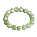 Green milk-in-water Xiuyan jade bracelet with geometric beads and polished finish