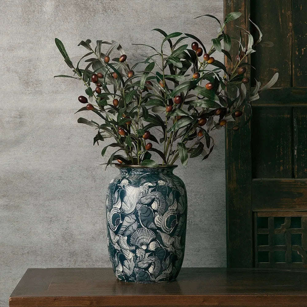 New Chinese retro artistic ceramic vase with dried flowers on a tabletop in a home living room setting