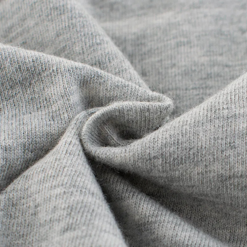 Grey children's cotton T-shirt laid flat, showing size tag with centimetre measurements.