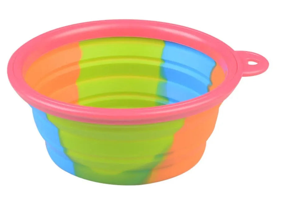 Collapsible silicone dog bowl in camouflage pattern folded flat on green surface