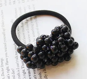 Cloth beaded hair rope in black colour on a white background