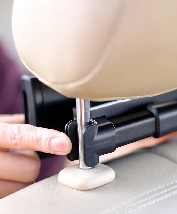 Black universal car phone holder mounted on rear seat base with tablet secured in clamp