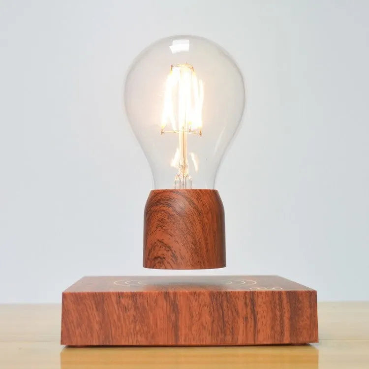 Magnetic levitation floating light bulb hovering above an imitation wood base.