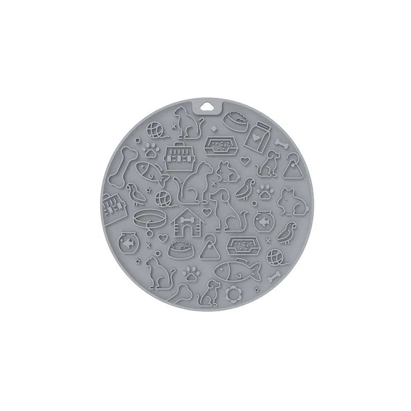 Round blue silicone pet licking mat with sucker base on a floor.