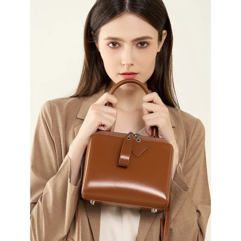 Open grain leather handbag with cowhide lining and welt pocket in black, brown or creamy white