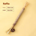 Wooden cat teeth grinding rod with catnip stem and raffia decoration, 2.2cm thick.