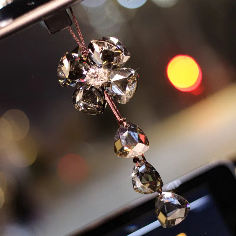 Crystal Four Leaf Grass car interior hanging pendant approximately 20cm long on a clear background.