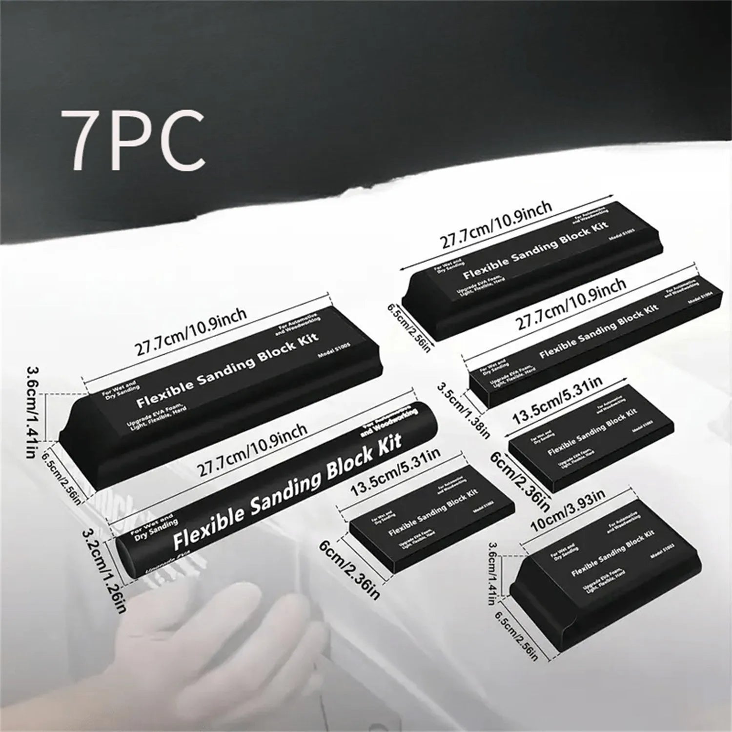 Seven black frosted metal building blocks arranged for architectural model assembly