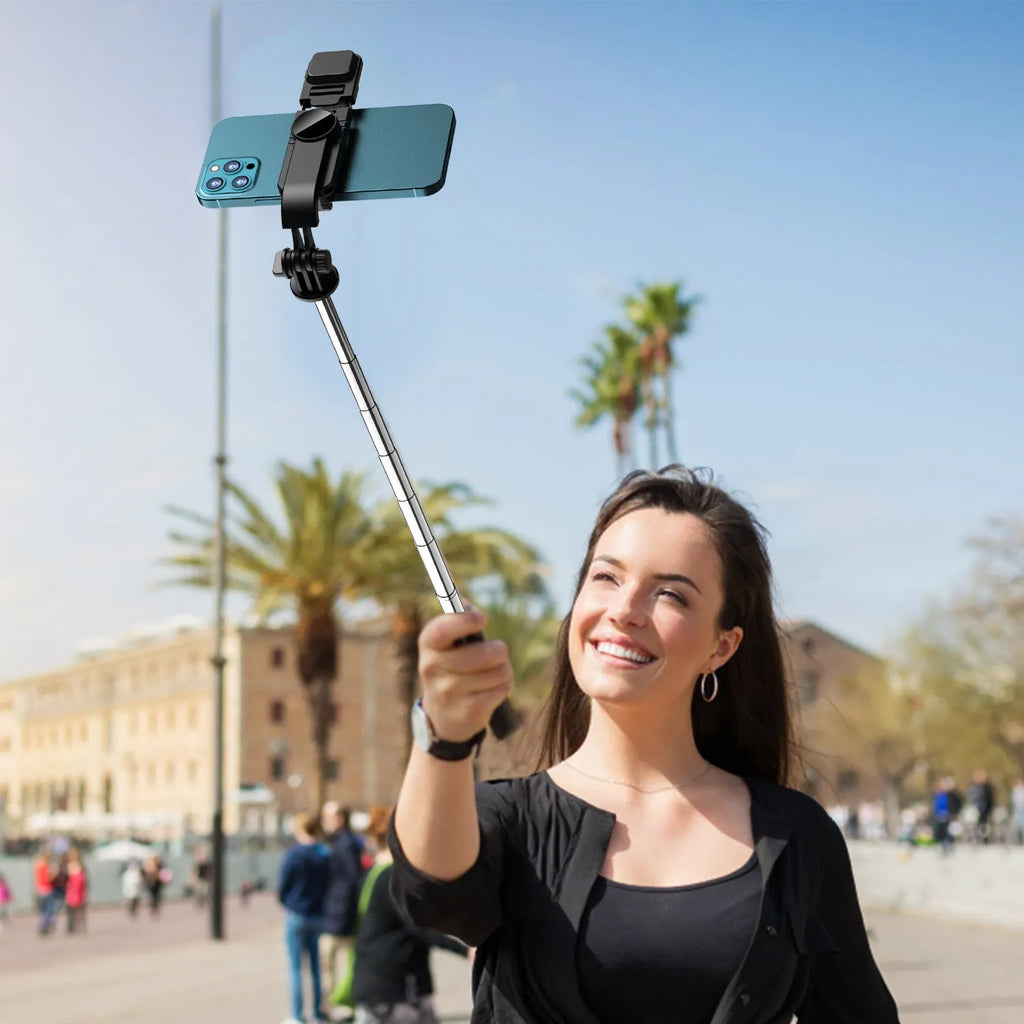 Portable retractable selfie stick tripod with Bluetooth remote and stainless steel shaft in black on a flat surface