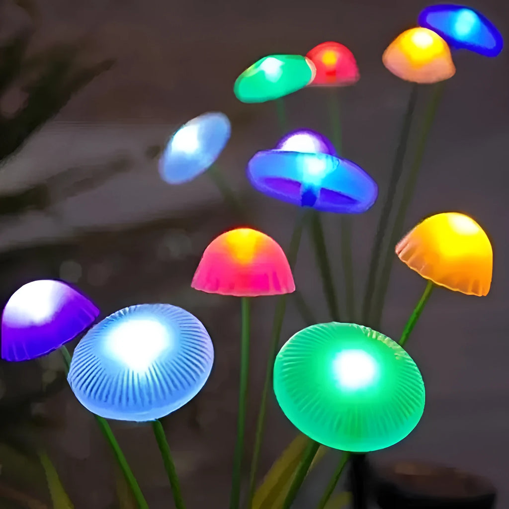 Solar jellyfish silicone garden lamp with warm LED lights on grass.