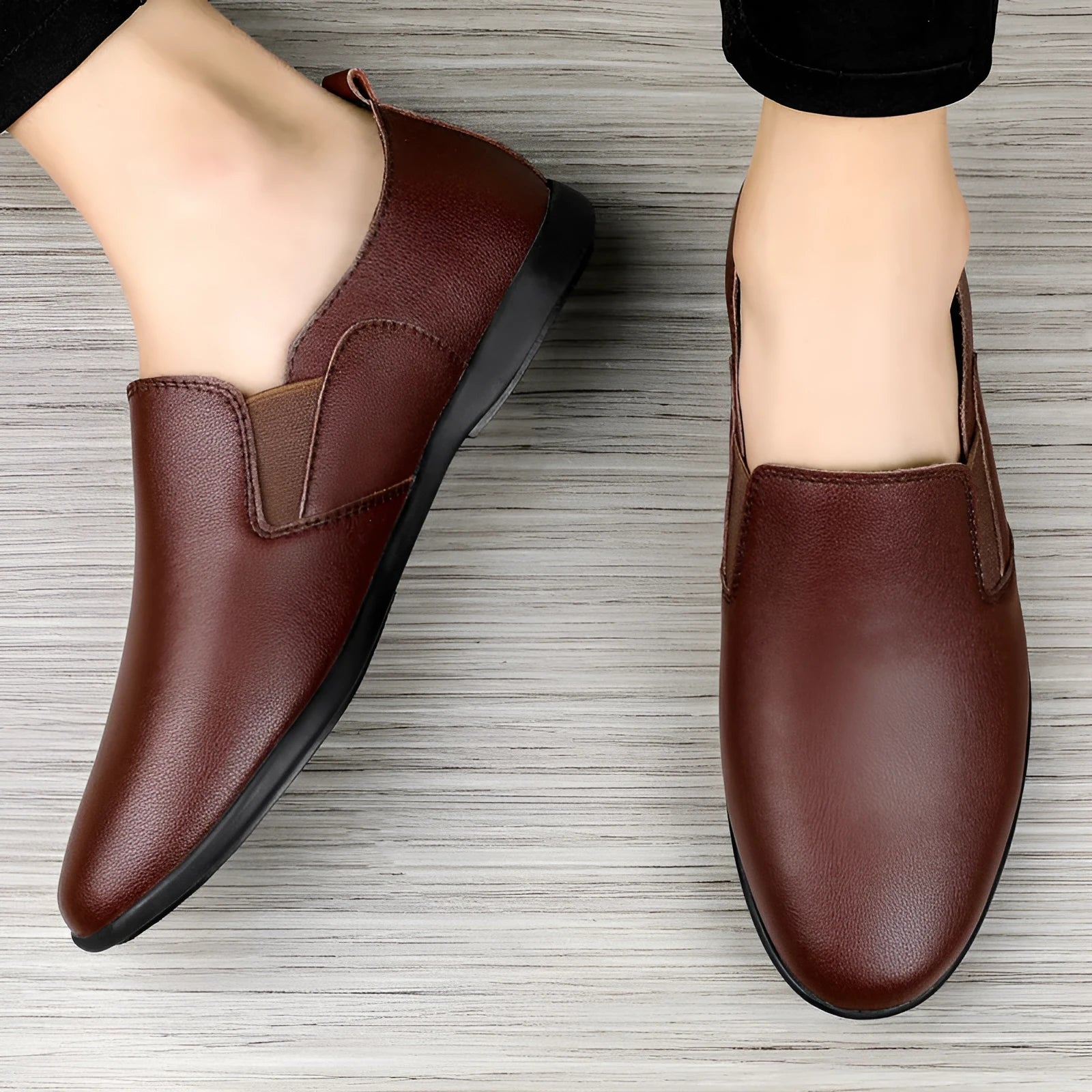 Men's black and brown cowhide leather shoes with round toes on a white background.