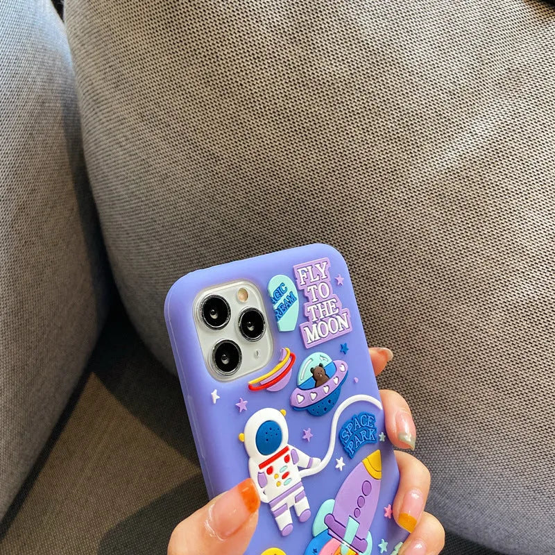 Purple silicone iPhone case with a detailed cartoon astronaut design on the back.