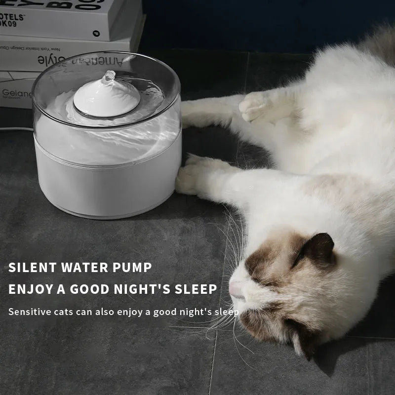 White ABS automatic cat drinking fountain on a flat surface with water in the bowl