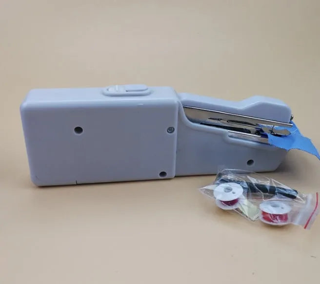 Handheld mini sewing machine set with thread spools, scissors, ruler, and clips in multiple colours