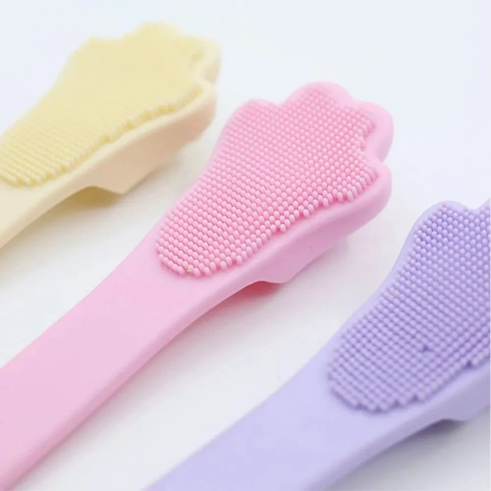 Pink silicone finger cover toothbrush for pets on a white background