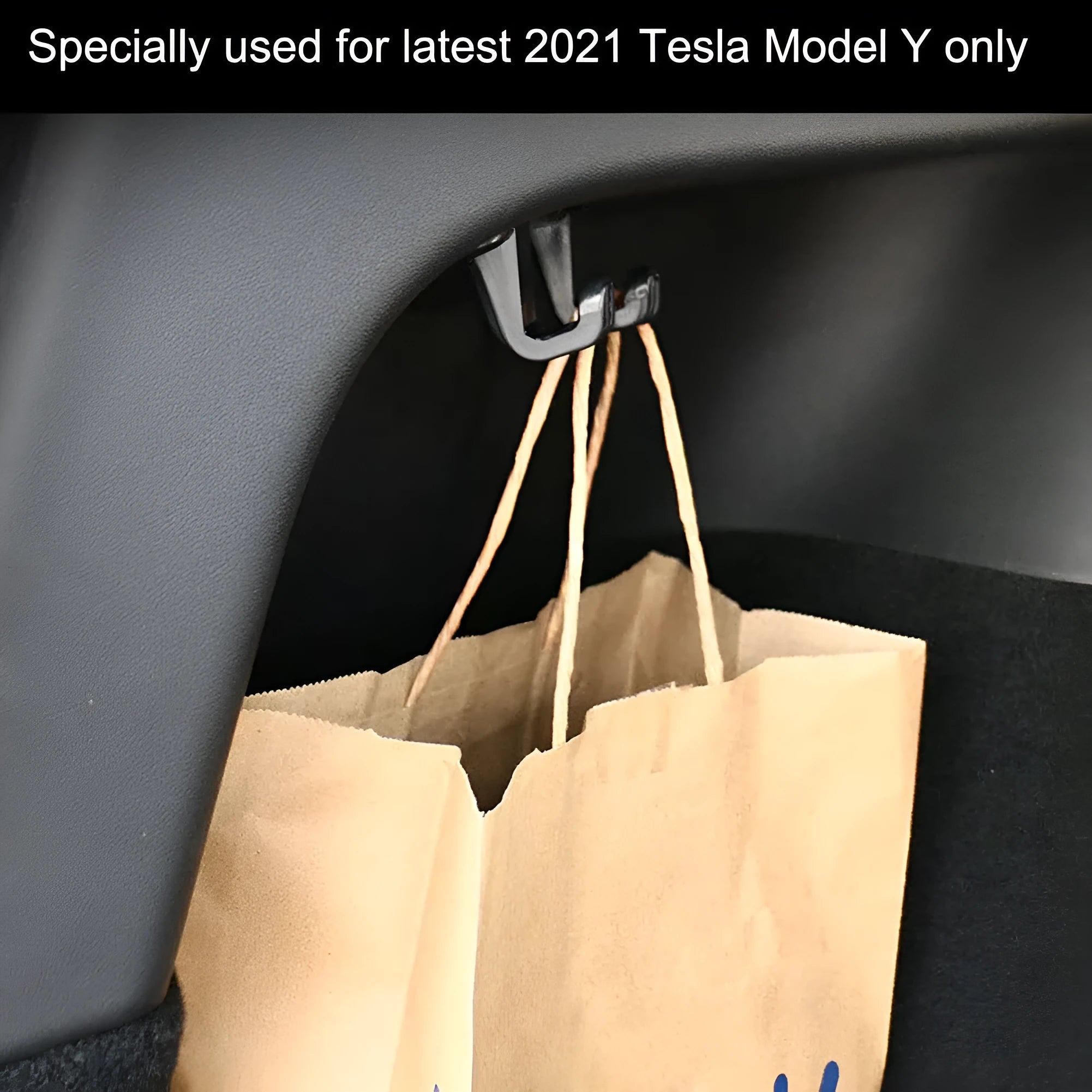 Single black ABS plastic trunk lid hook for Tesla Model Y on dark surface