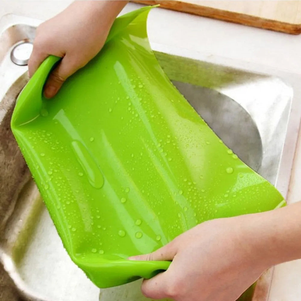 Rectangular silicone pet table mat under a dog bowl, available in multiple colours including black, blue, green, orange, purple, red, white, and yellow