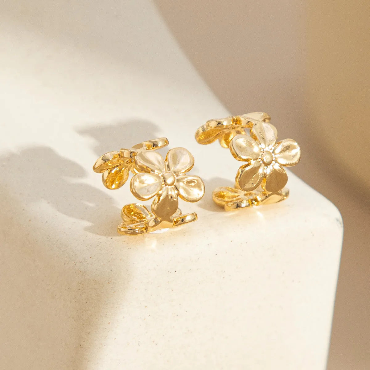 Gold women's drop earrings with a starfish and conch design on alloy hooks.