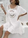 Apricot coloured beach dress with crochet stitching and tassel trim on a patchwork skirt.