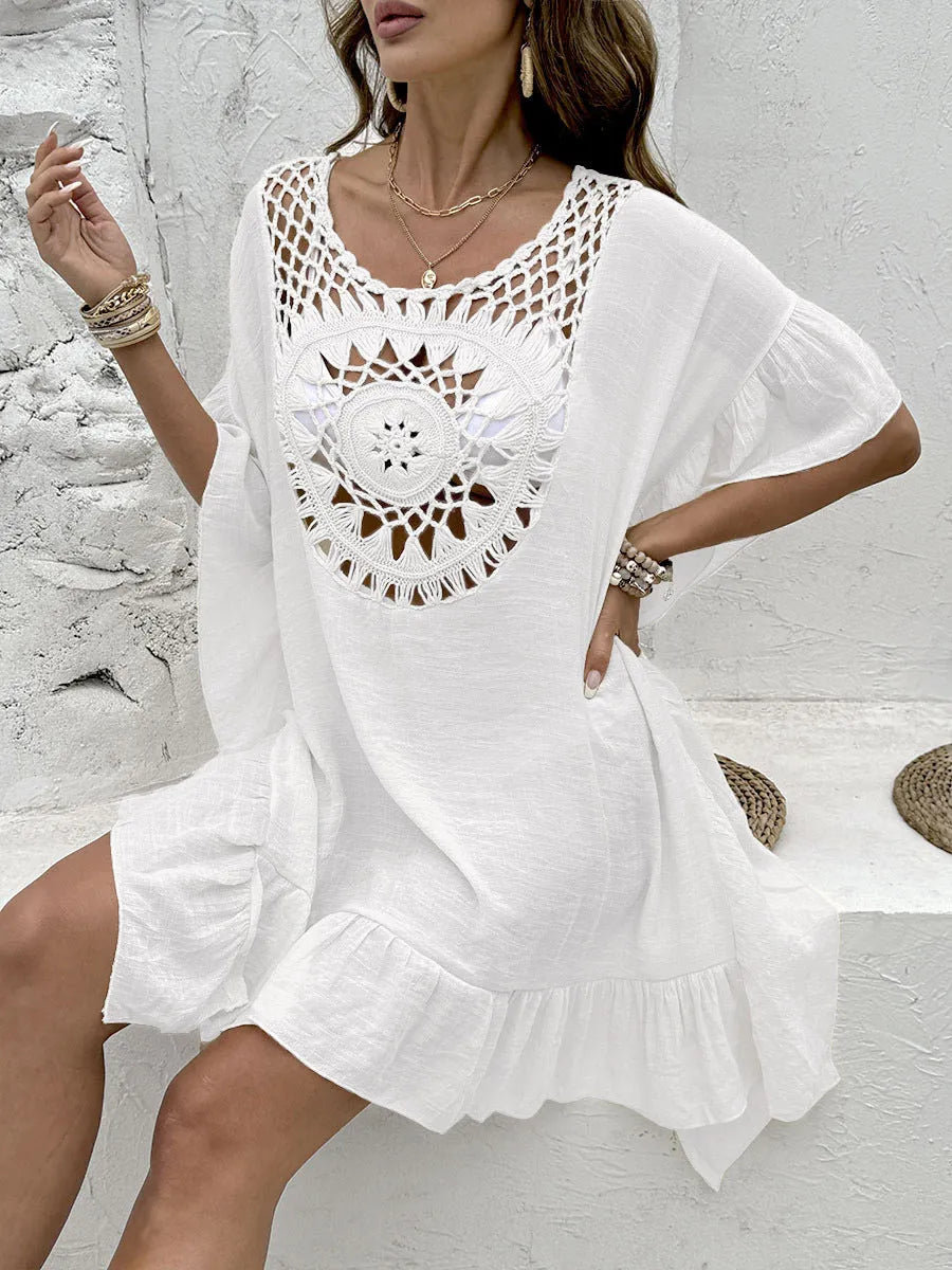 Apricot coloured beach dress with crochet stitching and tassel trim on a patchwork skirt.