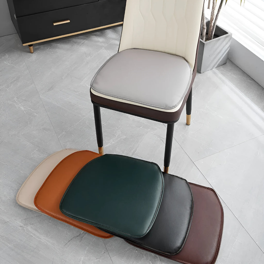 A solid-colour leather horseshoe-shaped seat cushion on a chair, showing its non-slip base and 2.5cm thickness.