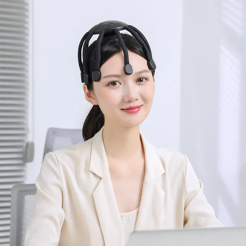 Black USB rechargeable head massager with multiple vibrating claws on a white background.