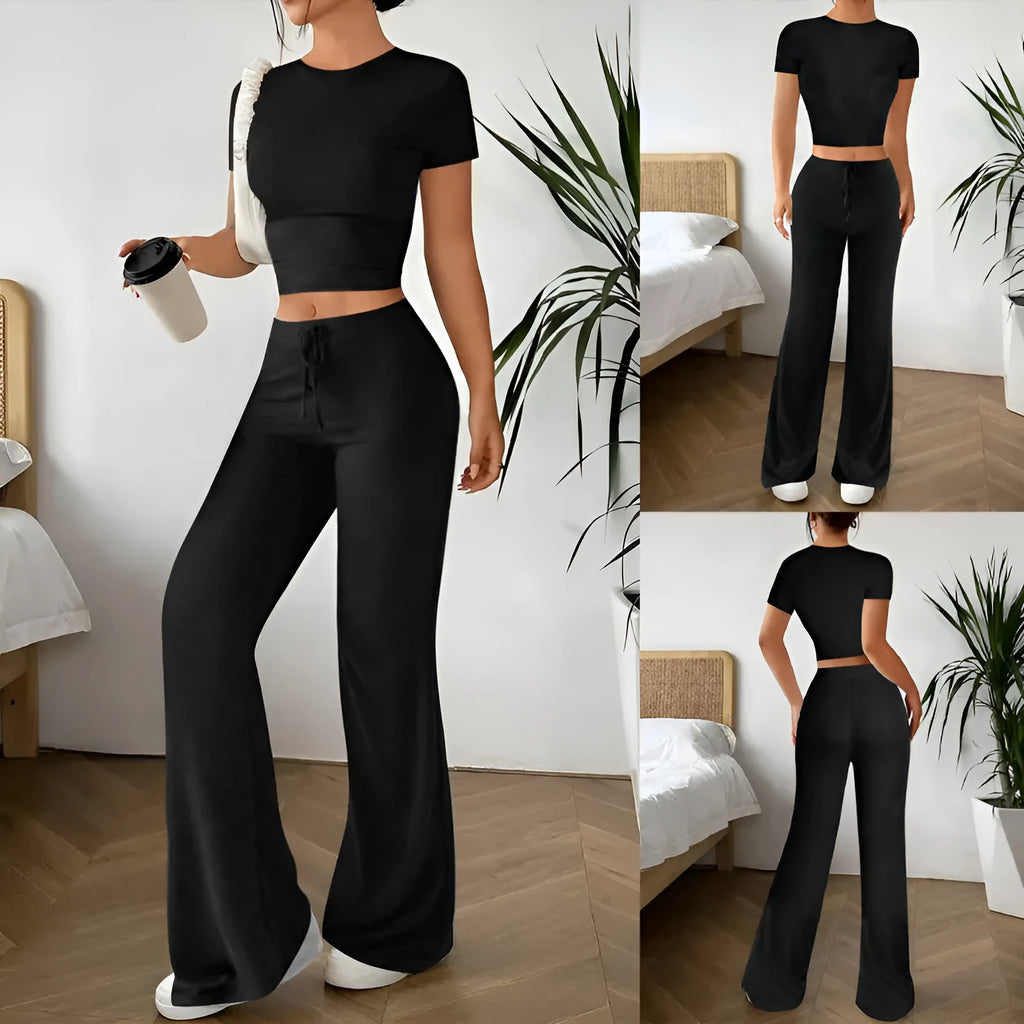 Black women's high waist trousers and short sleeve T-shirt lounge suit set on a plain background.