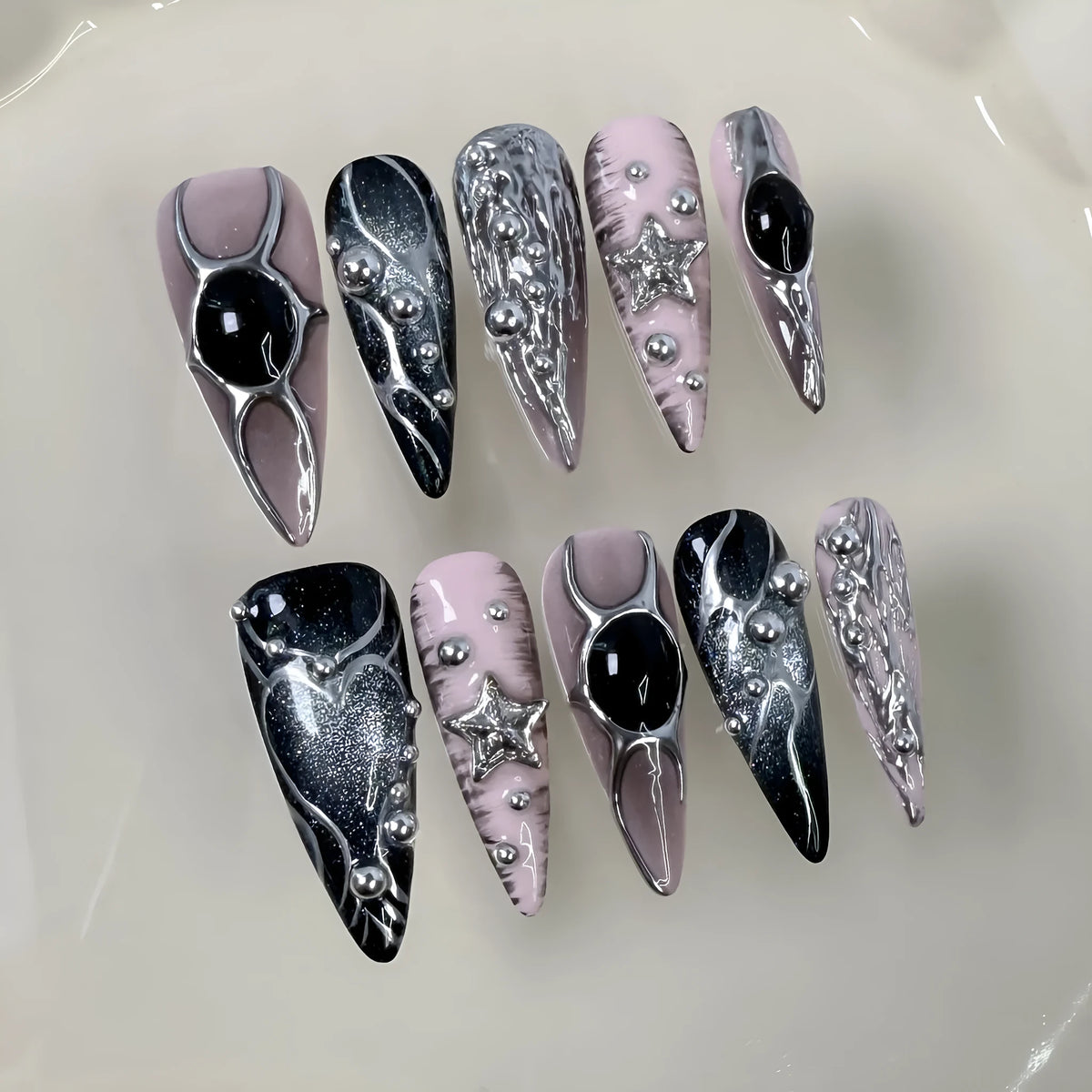 Long pointed press-on false nails with embossed relief and hand-painted metal detail in XS S M L sizes