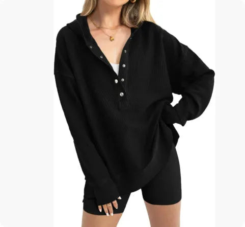 Women's loose peach-coloured pullover sweater with raglan sleeves on a hanger.