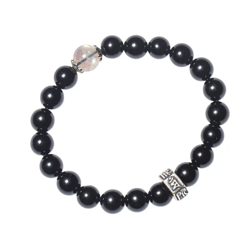 Obsidian bracelet with 8mm beads and a Tibetan zodiac charm on a wrist.