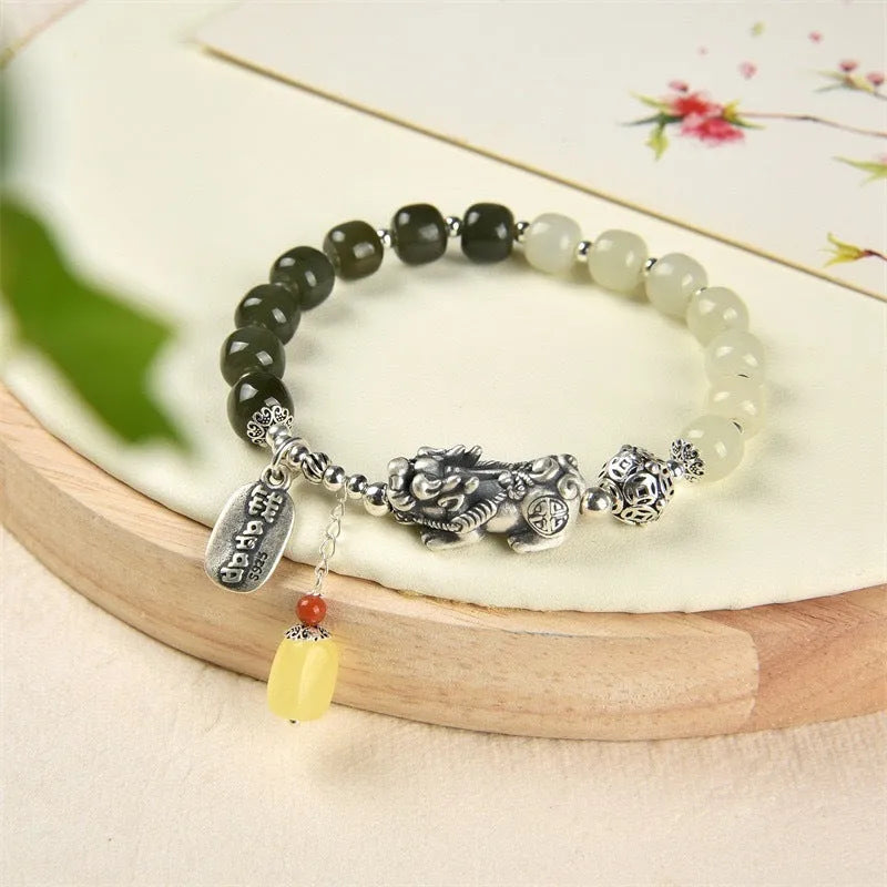 Retro women's silver coin bracelet with a natural Hetian jade stone.